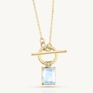 Gold necklace with a pendant featuring a moonstone on a white background