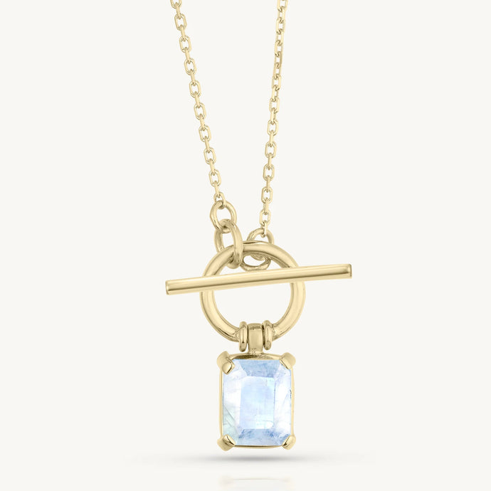 Gold necklace with a pendant featuring a moonstone on a white background