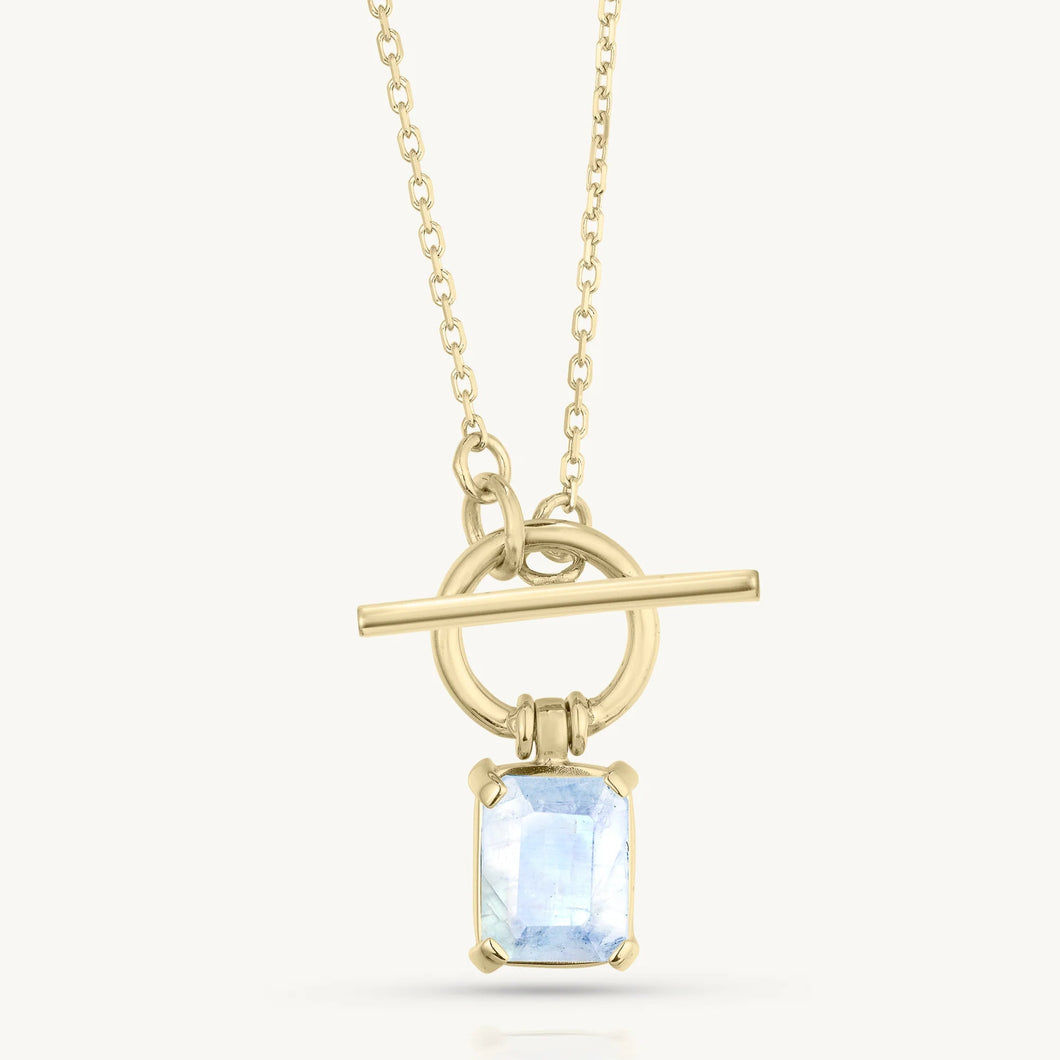 Gold necklace with a pendant featuring a moonstone on a white background