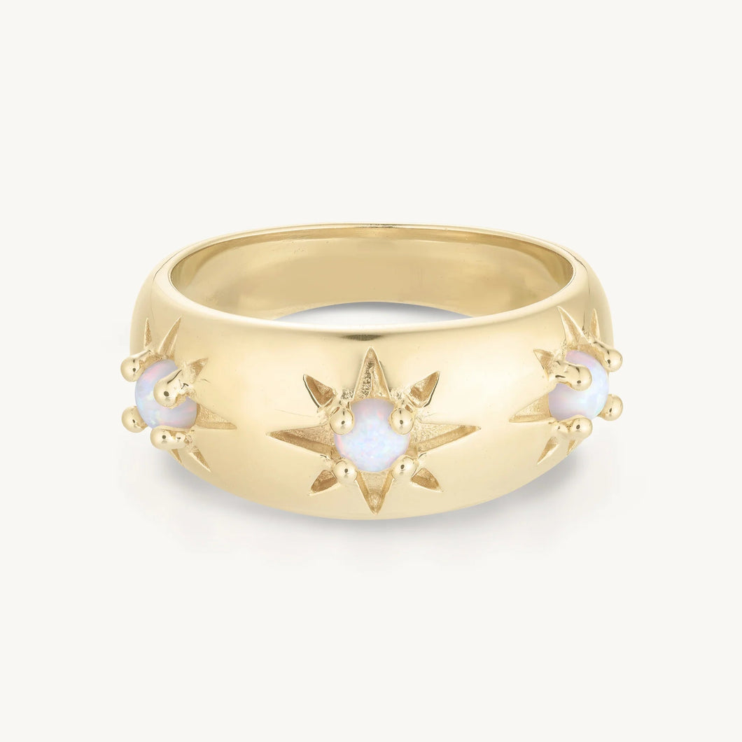 Gold ring with star design on a white background