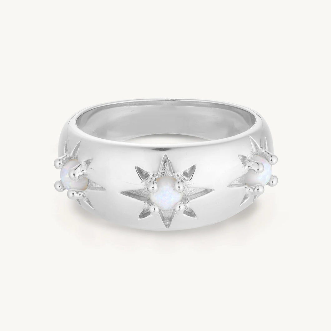 Silver ring with star design on a white background