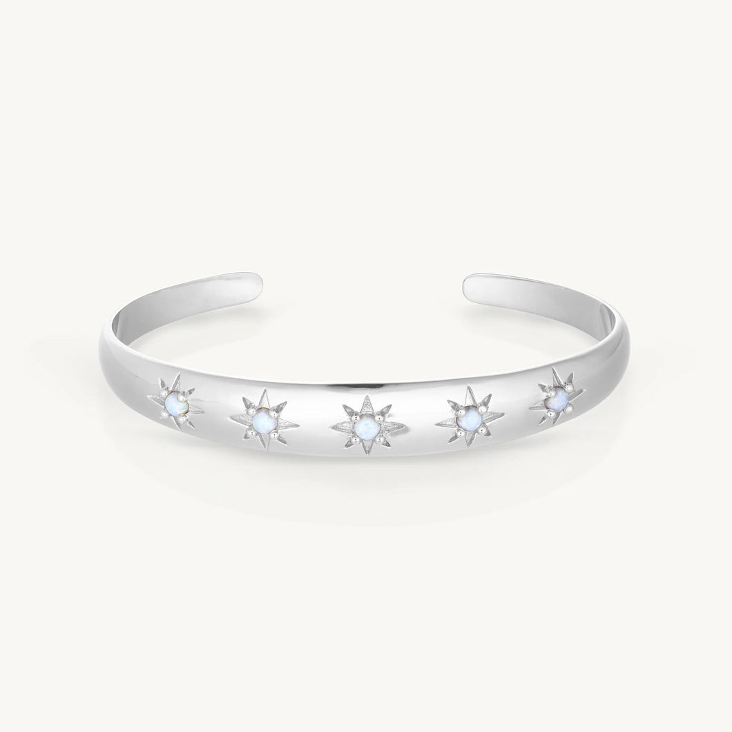 Silver bracelet with star-shaped stones on a white background
