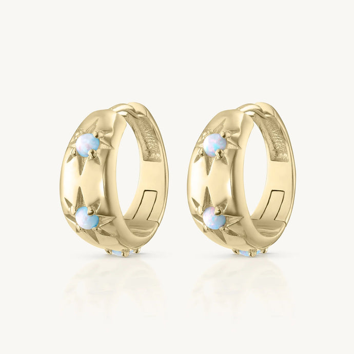 Pair of gold hoop earrings with small stones on a white background