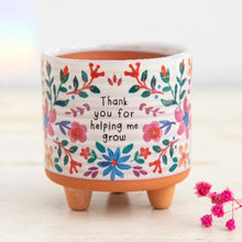 Load image into Gallery viewer, Ceramic pot with floral designs and text on a white background