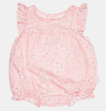 Load image into Gallery viewer, A pink sleeveless baby romper with a delicate white floral print, featuring ruffled shoulder straps and a ruffled leg opening, shown flat on a light background.