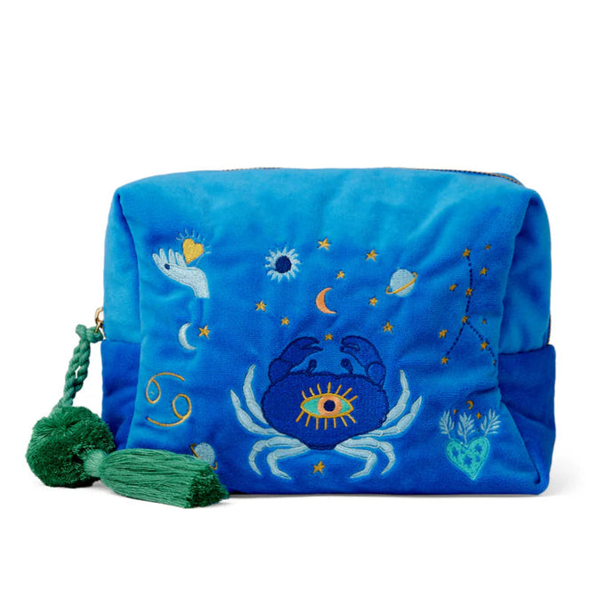 Blue pouch with celestial designs and a green tassel on a white background