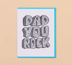 Card with 'Dad You Rock' text on a beige background