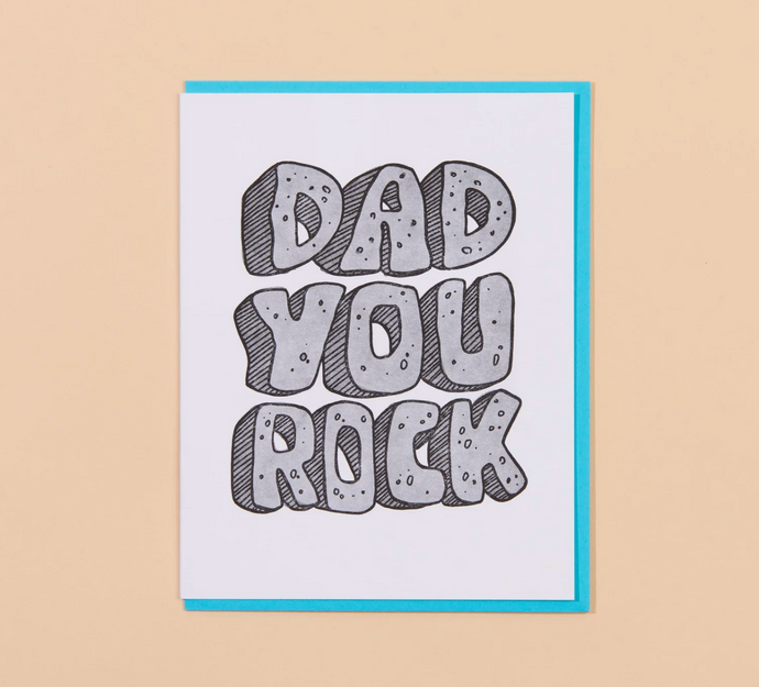 Card with 'Dad You Rock' text on a beige background