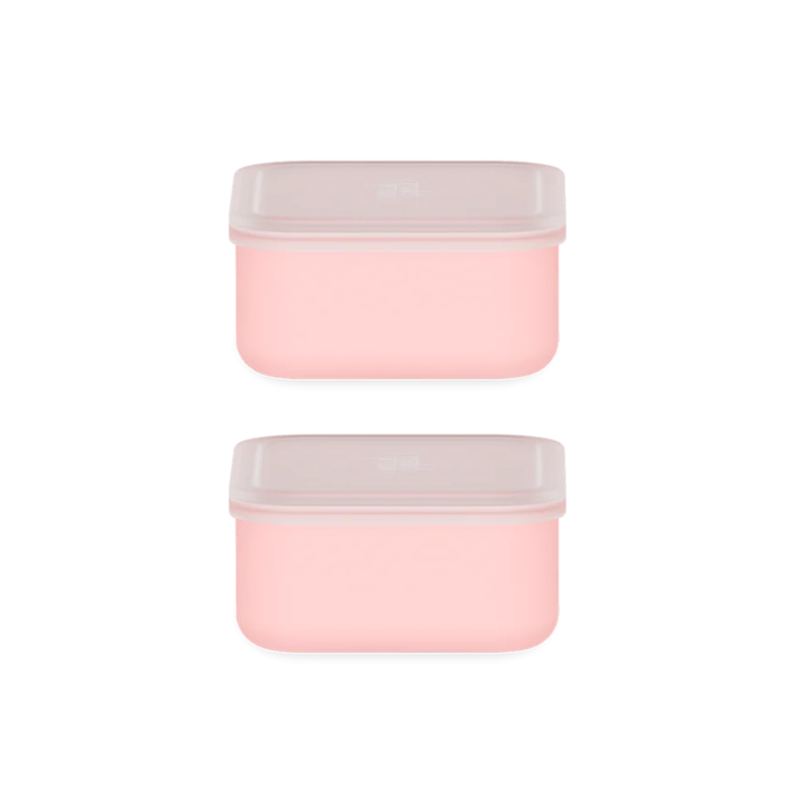 Two pink containers with white lids on a white background