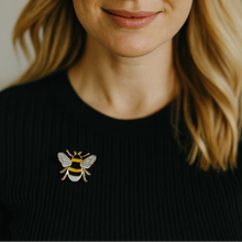 Load image into Gallery viewer, Woman wearing a black sweater with a bee brooch on a neutral background