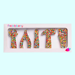 Freckle tool-shaped chocolates in a box with 'freckleberry' branding on a light blue background.