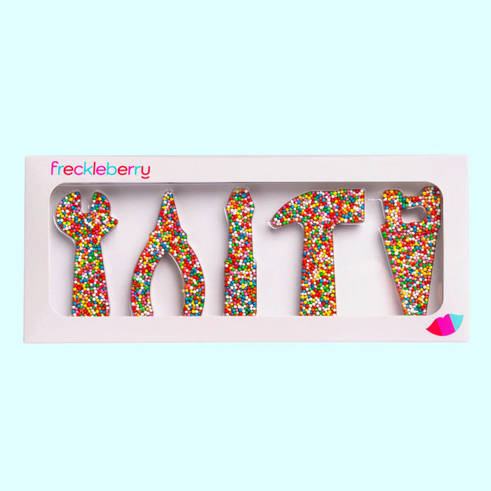 Freckle tool-shaped chocolates in a box with 'freckleberry' branding on a light blue background.