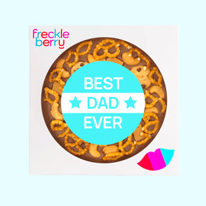 Chocolate pizza loaded with pretzels, cookies, cashews and caramel fudge and a 'Best Dad Ever' message on a light blue background