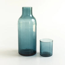 Load image into Gallery viewer, Blue glass bottle and cup on a white background