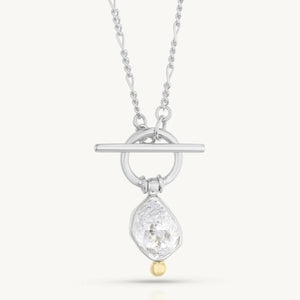 Silver necklace with a teardrop-shaped pendant on a white background