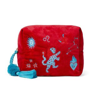 Red pouch with blue tassel and embroidered designs on a white background