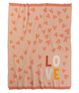 Pink blanket with heart patterns and 'LOVE' text on a white background