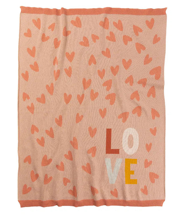 Pink blanket with heart patterns and 'LOVE' text on a white background