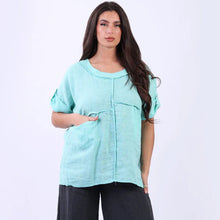 Load image into Gallery viewer, Woman wearing a light blue top and black pants on a white background