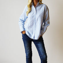 Load image into Gallery viewer, Person wearing a blue and white checkered shirt and dark jeans against a plain background