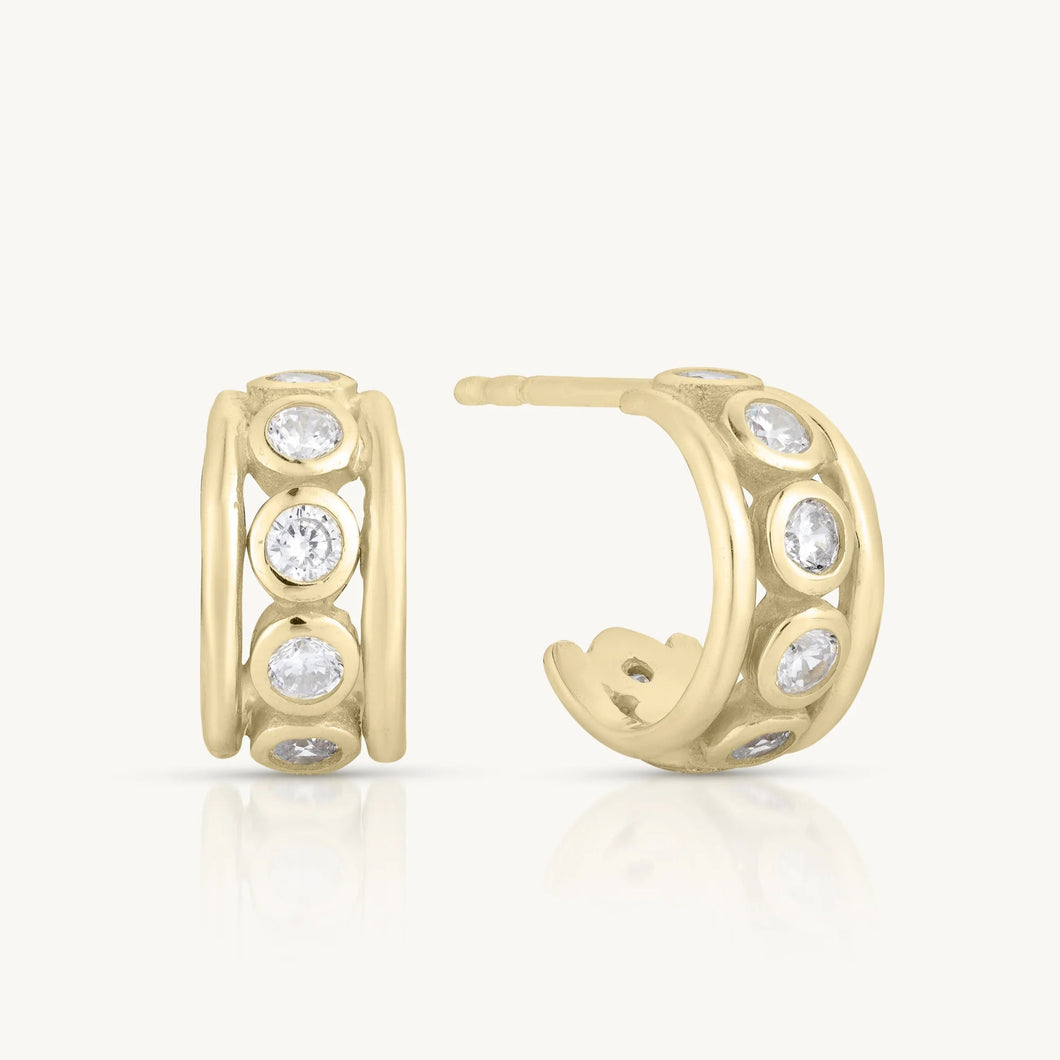 Gold hoop earrings with embedded stones on a white background