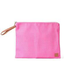 Load image into Gallery viewer, A pink and white gingham zippered pouch with a tan wrist strap and a small brown brand patch on the bottom right, set against a plain white background.